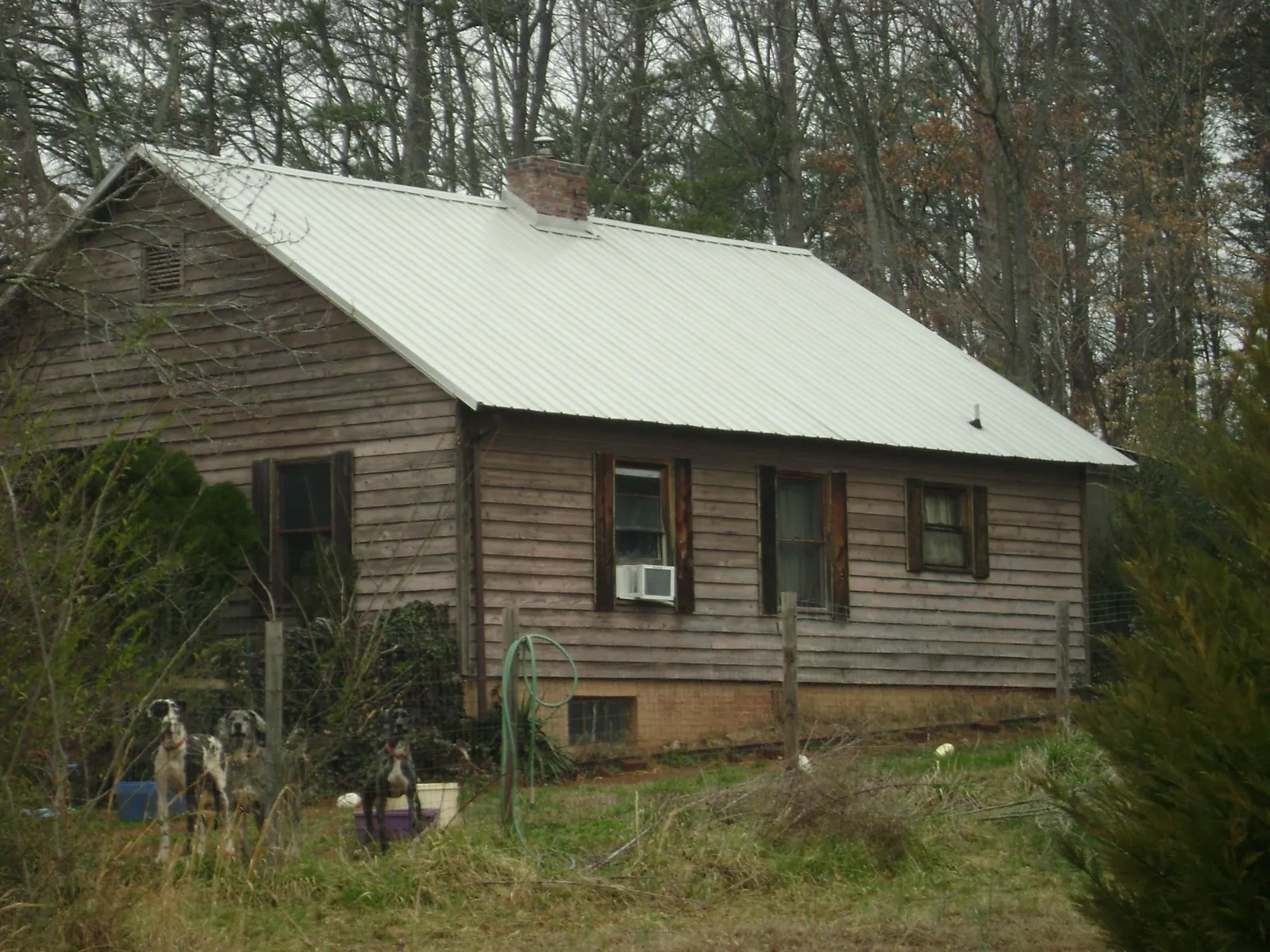 White metal roof on an old wood sided farmhouse, from a Metal Roof Installation job in Pottsville